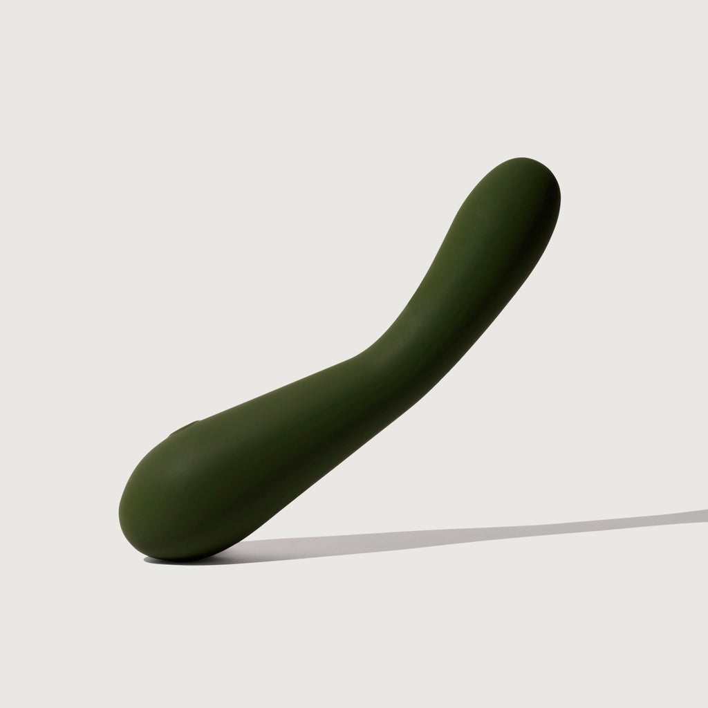 A green curved object against a plain background.