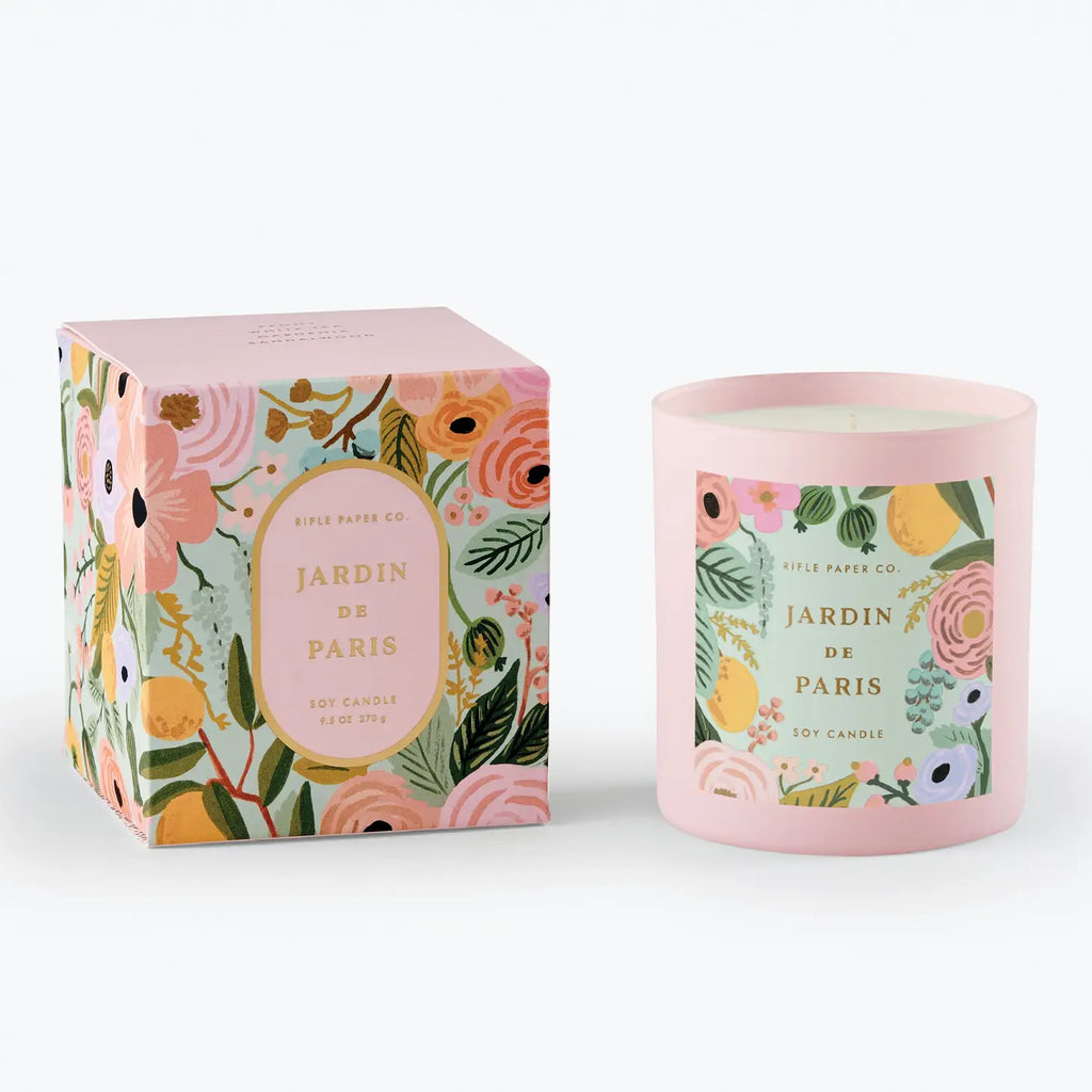 Floral-patterned candle with matching packaging, labeled "jardin de paris soy candle" by rifle paper co.