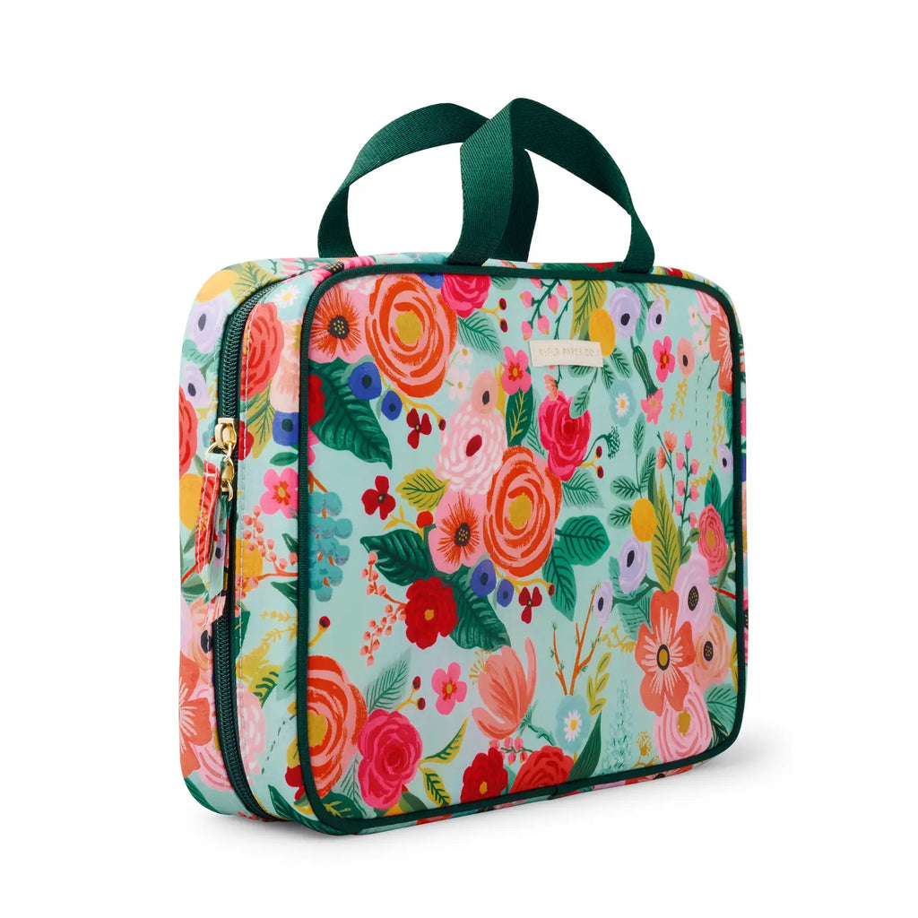 Colorful floral-patterned lunch bag with a green handle.