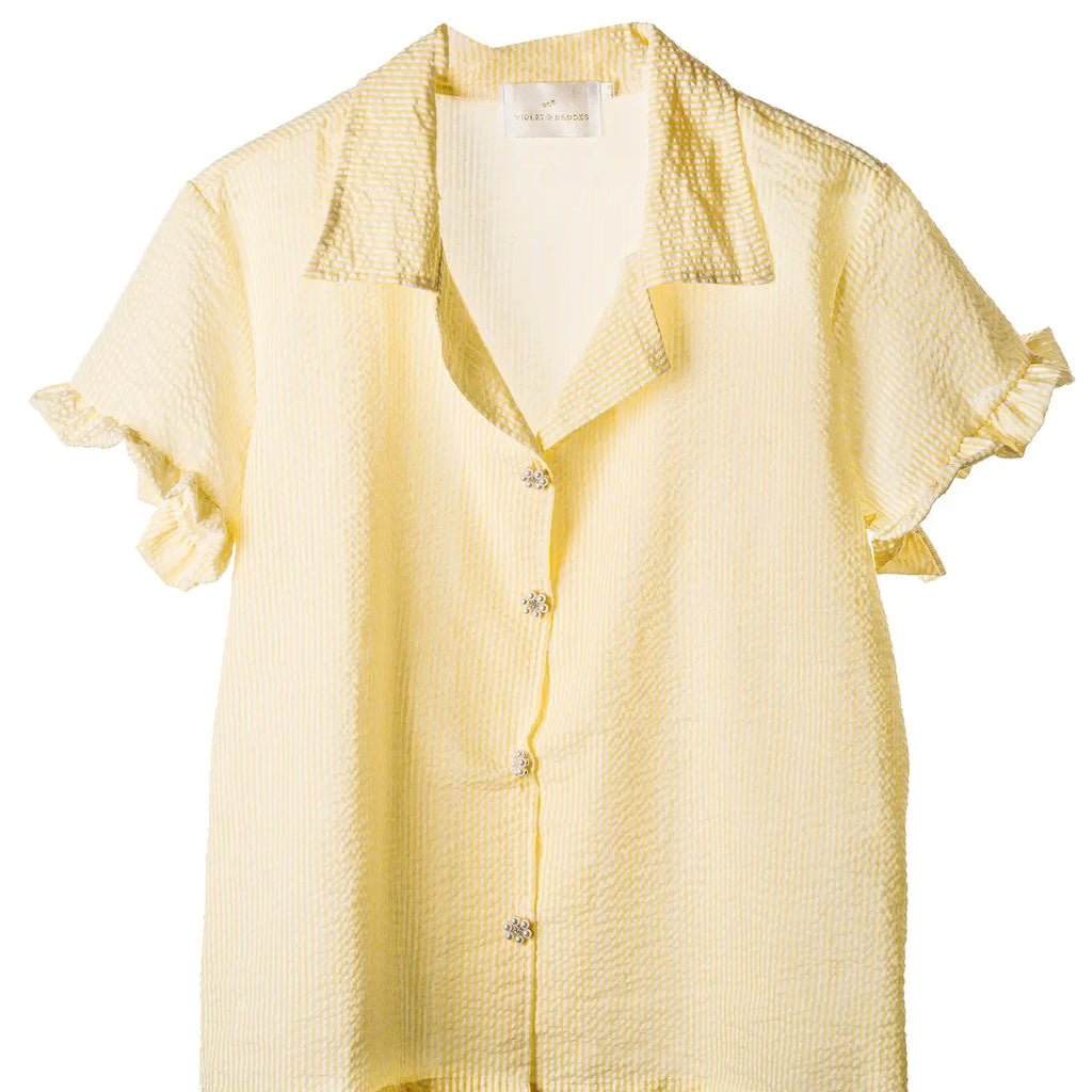 Violet & Brooks Skylar Short Sleeve Ruffle Top - Lemon with textured Cotton/Poly Soft Seersucker fabric and button-down front, displayed against a white background.