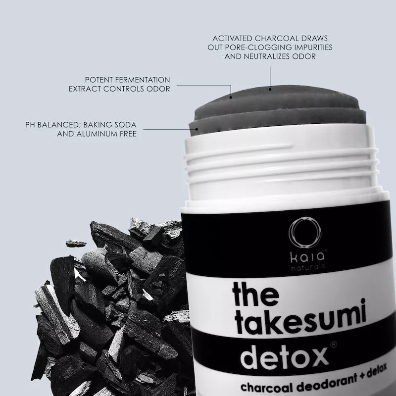 A deodorant stick with activated charcoal designed to draw out impurities and neutralize odor, positioned next to pieces of charcoal.