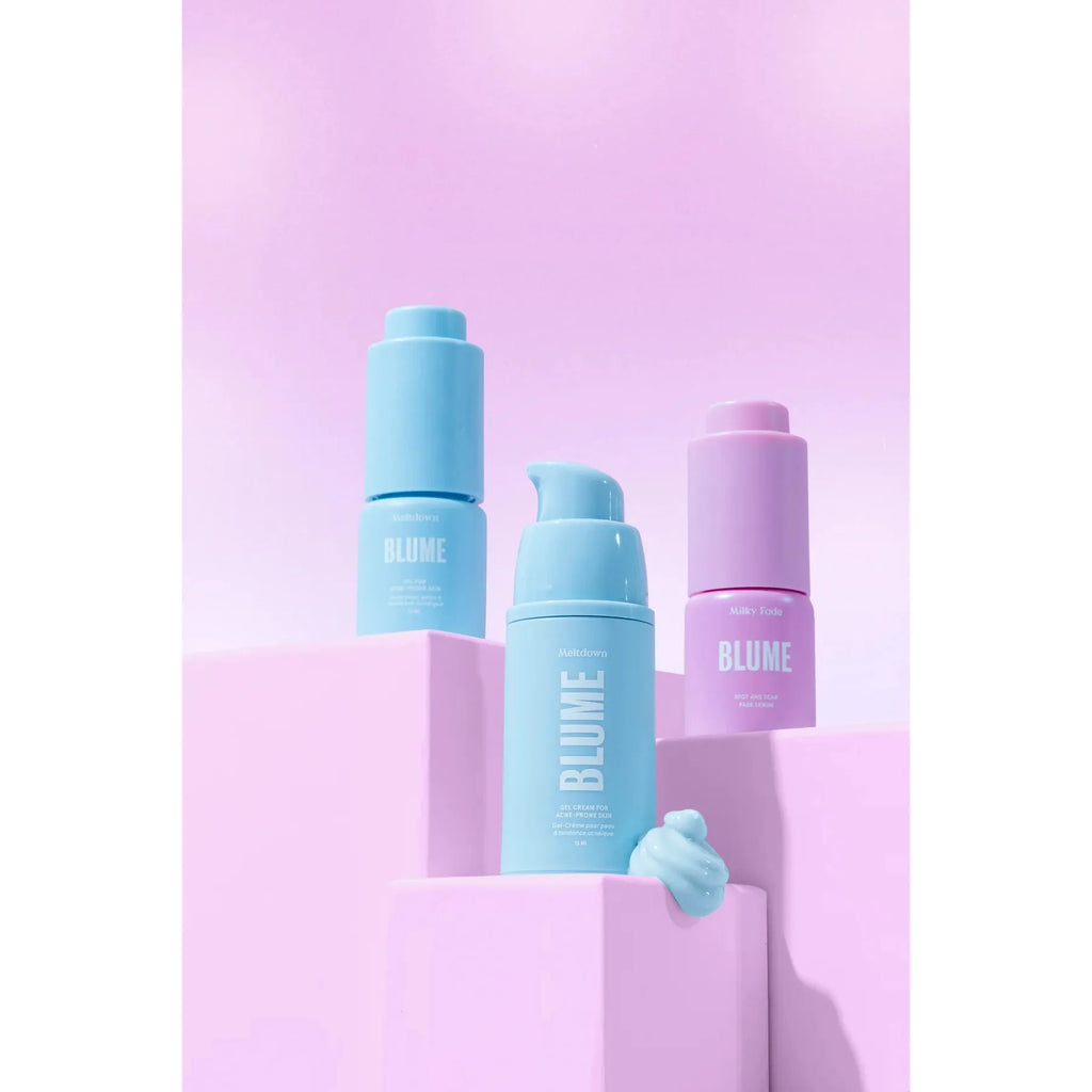 Beauty products from blume displayed on a pink background with varying shades of blue packaging.