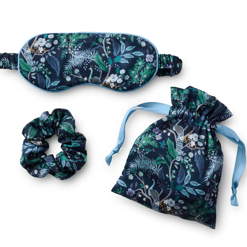 Sleep accessory set with patterned eye mask, drawstring pouch, and hair scrunchie.