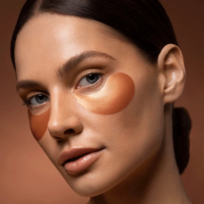 A close-up of a woman's face demonstrating contouring makeup with distinct brown tones on her cheek.