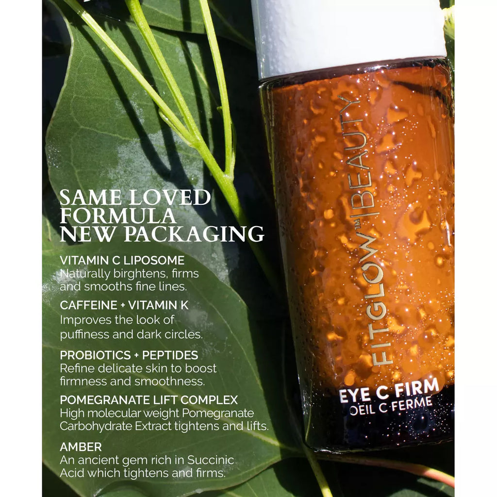 A bottle of fitglow beauty eye c firm cream with ingredients list and benefits, nestled among green leaves.