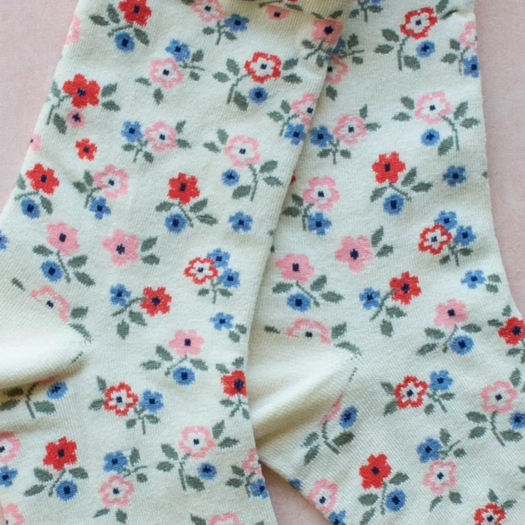 Pair of floral patterned socks with a pastel background.