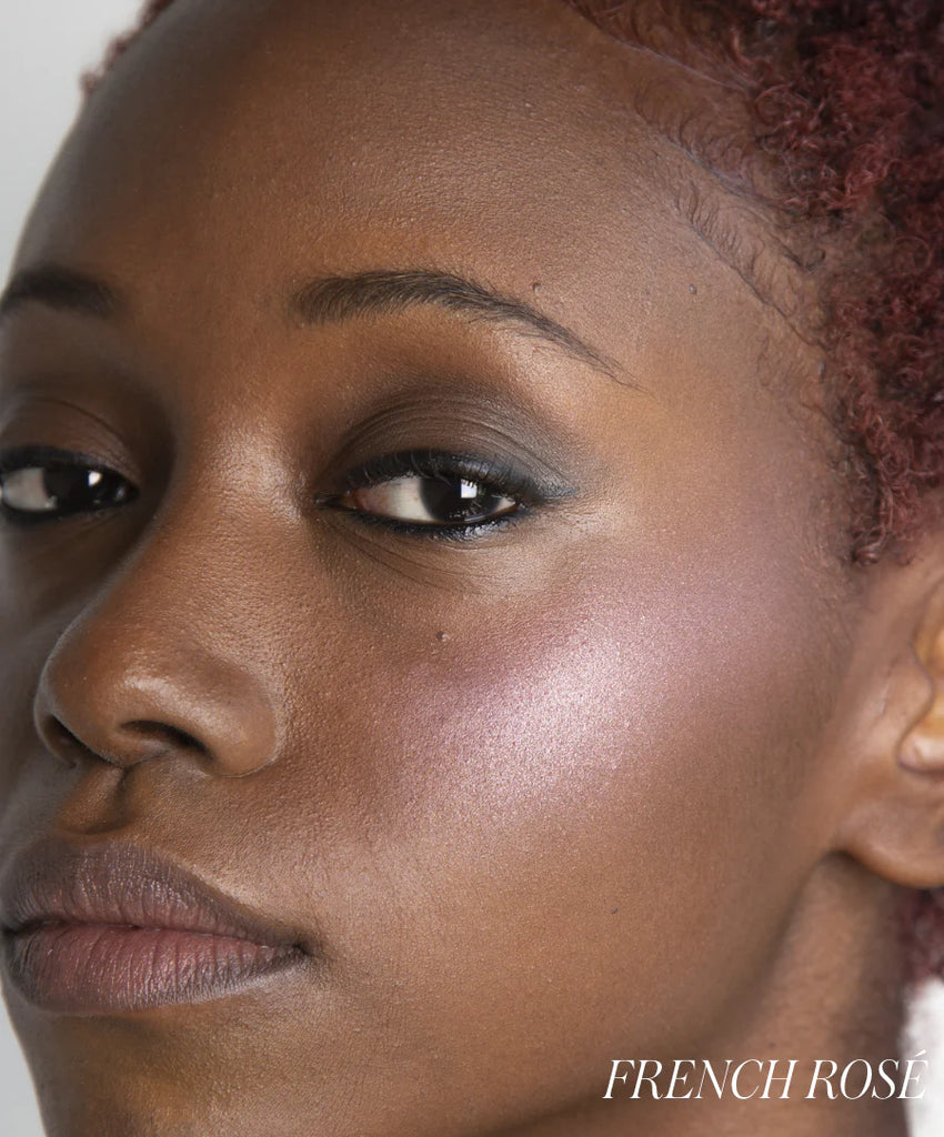 Close-up of a woman's face wearing 'French Rose'