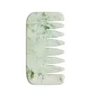 A green and white marbled hair comb.