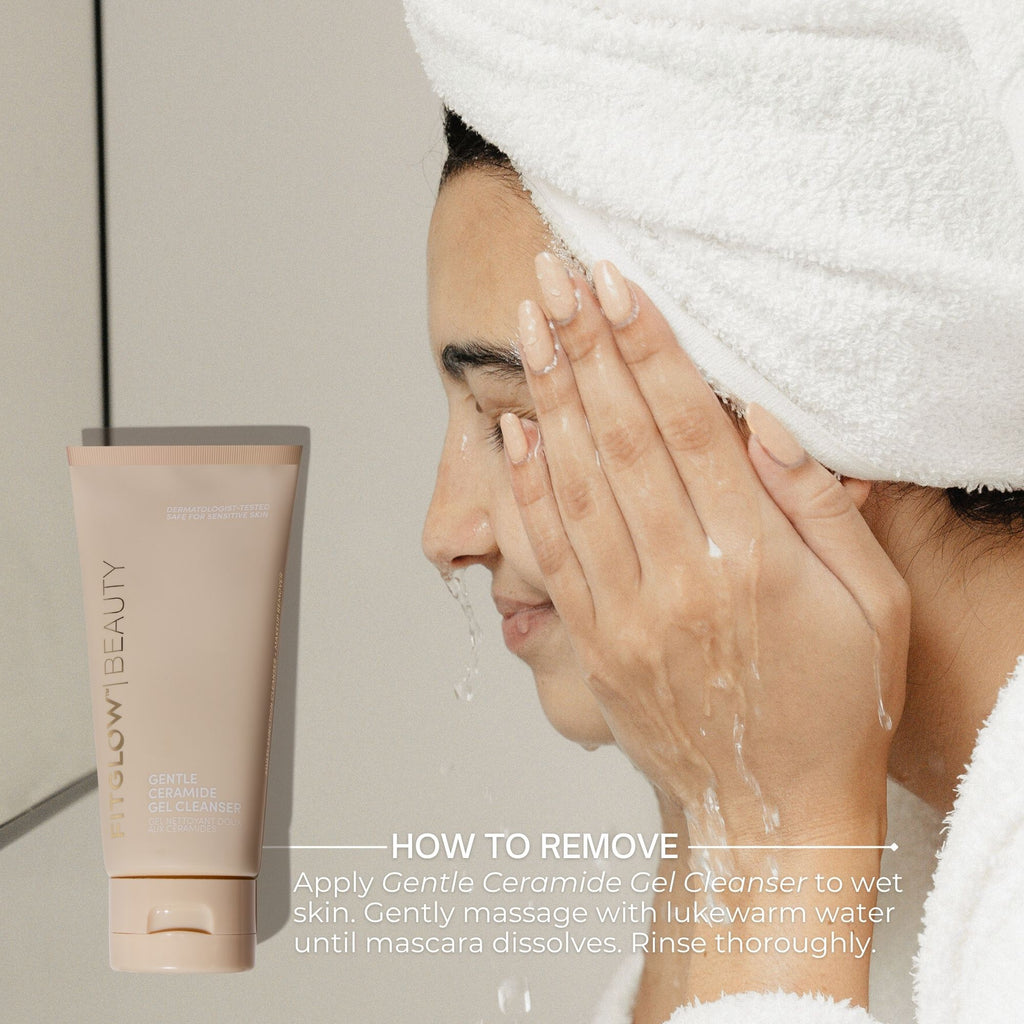 Person washing their face with a towel, next to a tube of Gentle Ceramide Gel Cleanser. 