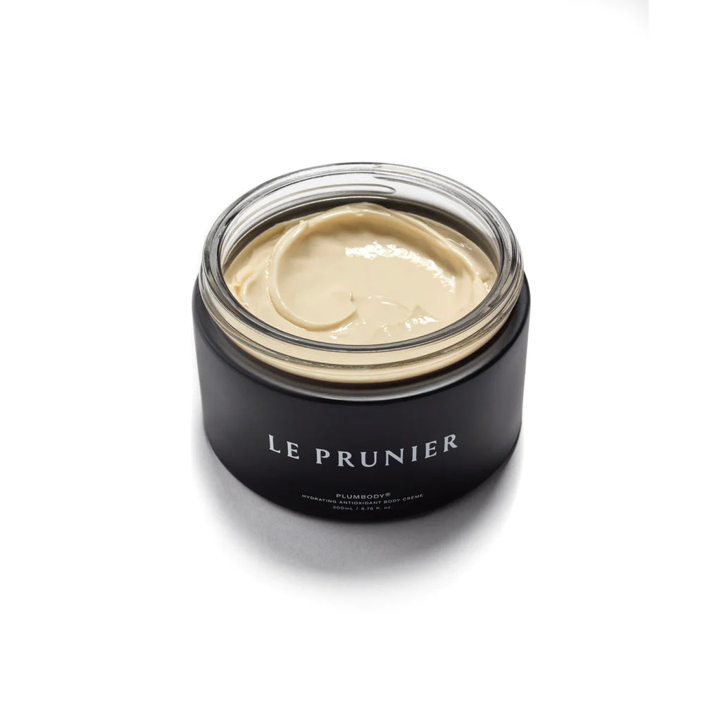 A jar of le prunier plum beauty oil on a white background.