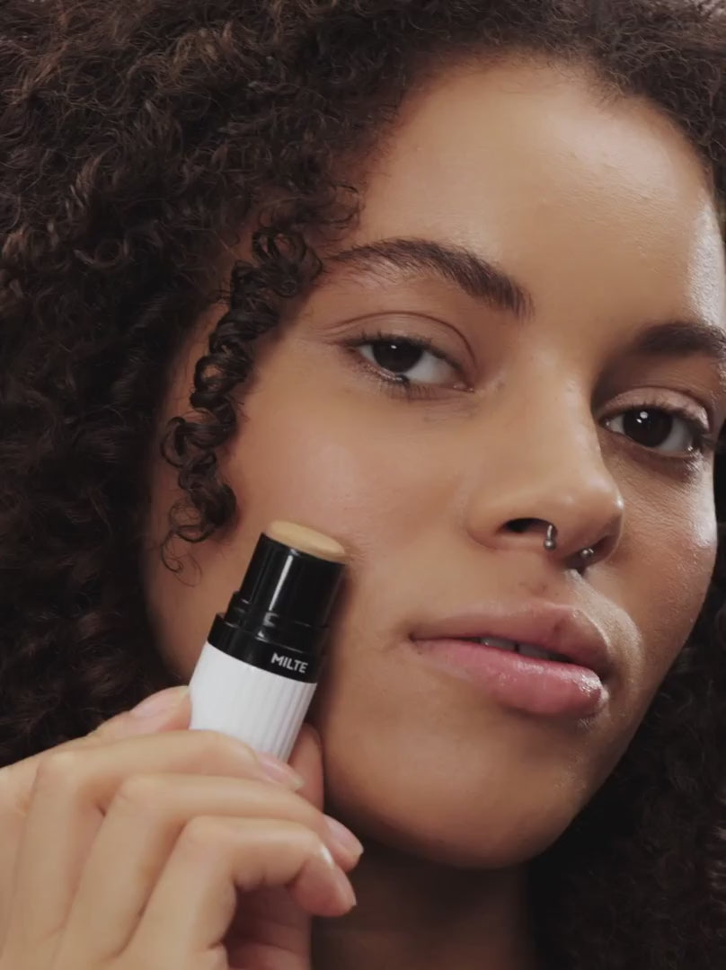 Model applying DEEP MEDIUM 06: Neutral light brown provides a soft-focus finish with buildable coverage in a soft-cream stick. Ideal for medium skin types, it blends effortlessly with the skin, conceals redness, smoothes wrinkles and offers a light, velvety feel.