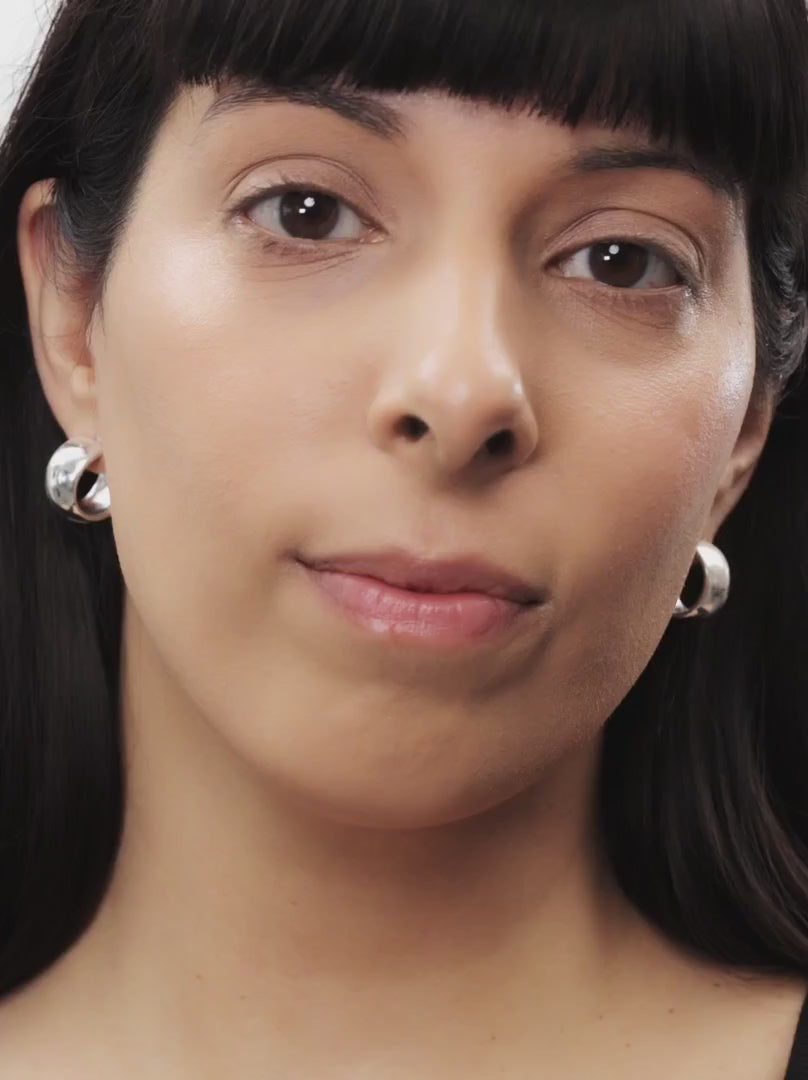 Model applying LIGHT MEDIUM 04: Deep, neutral-warm beige provides a soft-focus finish with buildable coverage in a soft-creamy stick. Ideal for medium-light to medium skin types, it blends effortlessly into the skin, conceals redness, smoothes fine lines and offers a light, velvety feel.