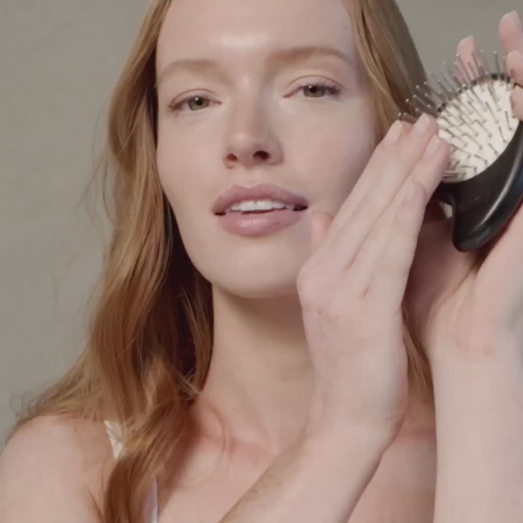 Person using Arey The Scalp Brush