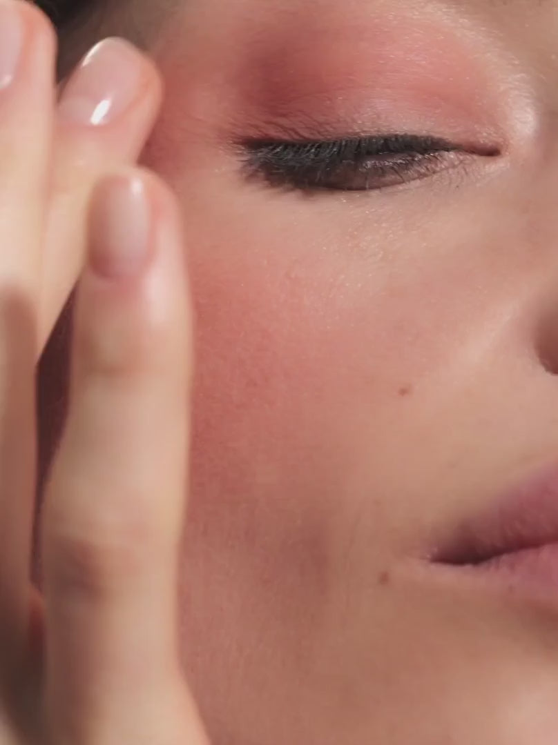 Model applying PEACH 02: Fresh peach shade with an elegant matte rosé finish - a natural hint of color for eyes and cheeks and a freshness kick for more intense looks.