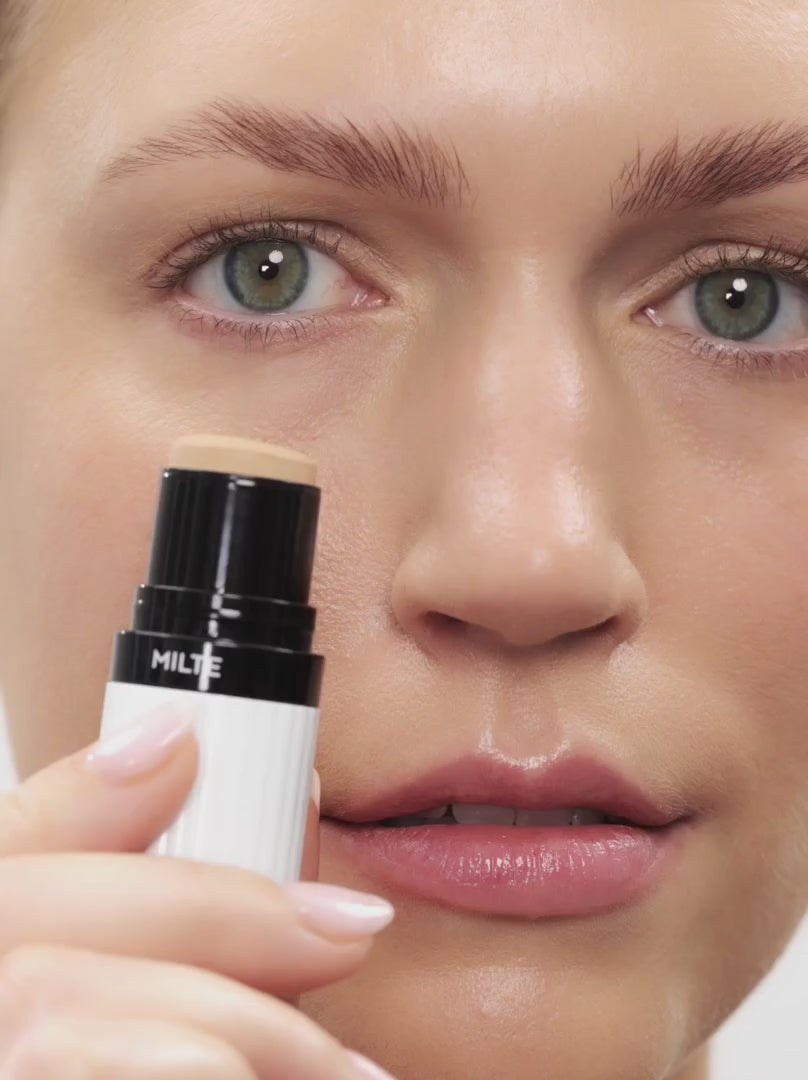 Model applying DEEP FAIR 03: Neutral, warm beige provides a soft-focus finish with buildable coverage in a soft-creamy stick. Ideal for light to medium-light skin types, it blends effortlessly into the skin, conceals redness, smoothes fine lines and offers a light, velvety feel.