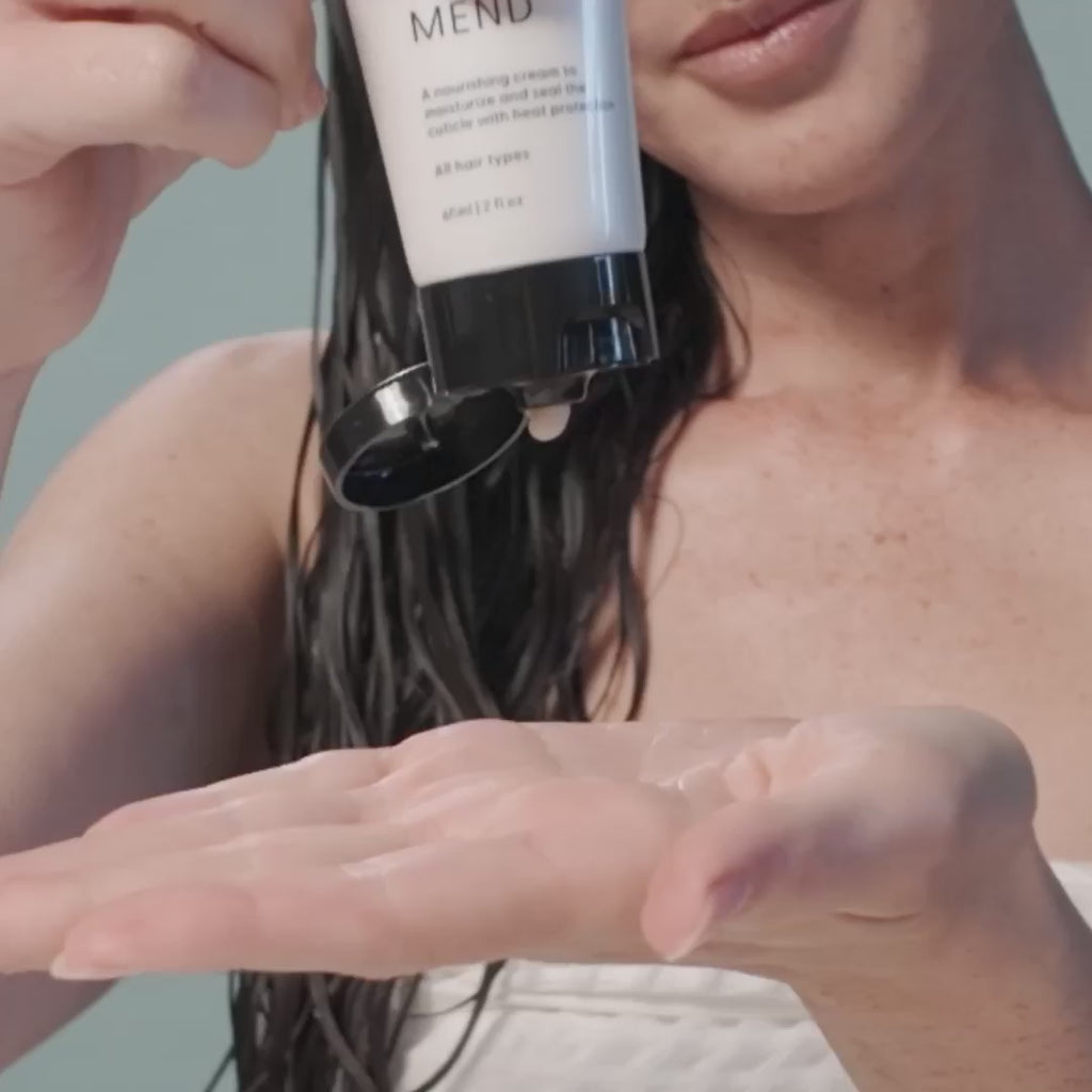 Video of a woman applying Arey Mend to damp hair