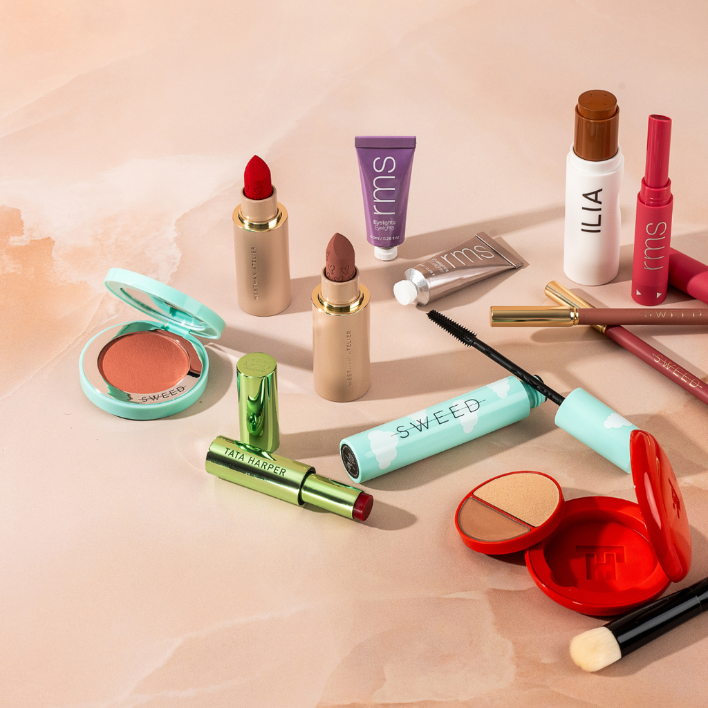 An array of cosmetics and beauty products spread out on a surface.