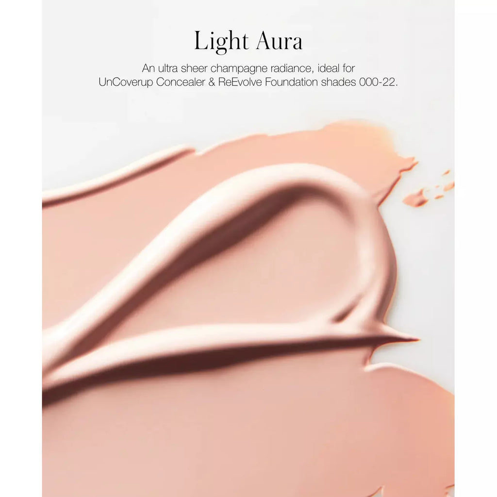 Swatches of light to medium shades of liquid makeup foundation artistically smeared on a surface.