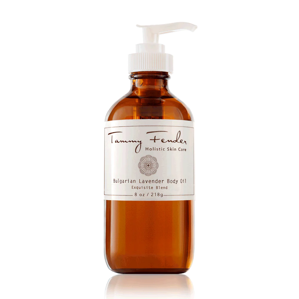 A bottle of tammy fender bulgarian lavender body oil with a pump dispenser on a reflective surface.