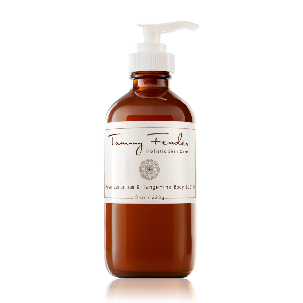 A bottle of "tammy fender holistic skin care" rose geranium and tangerine body lotion on a black background.