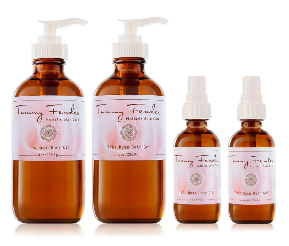 Four bottles from the Très Rose Collection by Tammy Fender Holistic Skin Care; two large pump dispensed bottles of "Très Rose Bath Gel" and two smaller spray bottles of "Très Rose Body Oil.