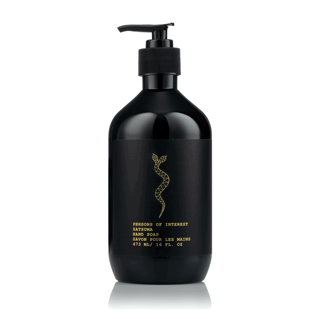 Black pump bottle of hand soap with gold text and design on a white background.