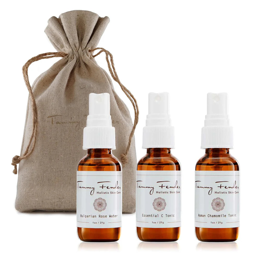 The Tammy Fender Floral Tonic Trio includes three rejuvenating bottles of holistic skin care products—Bulgarian Rose Water, Essential C Tonic, and Roman Chamomile Tonic—all packed in a stylish beige drawstring pouch.