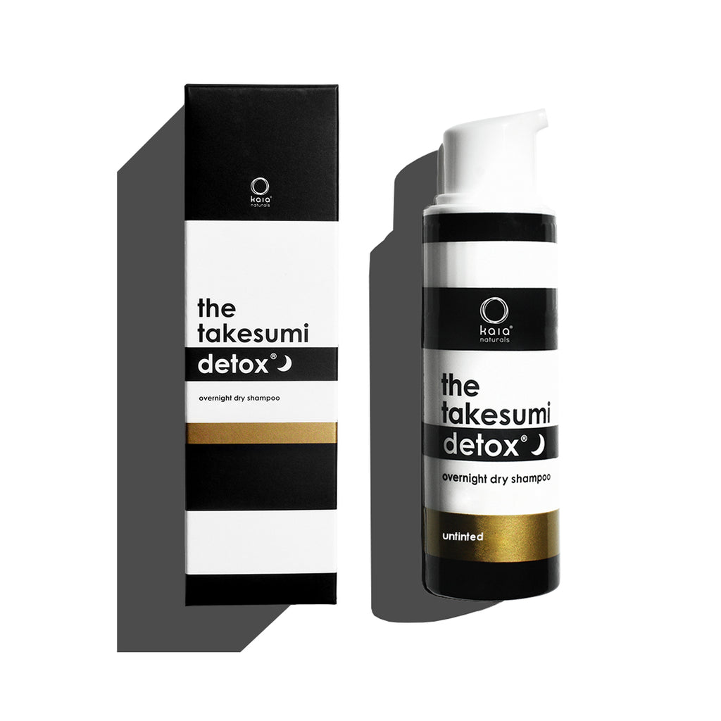 Product packaging and bottle of "the takesumi detox" overnight dry shampoo displayed against a white background.