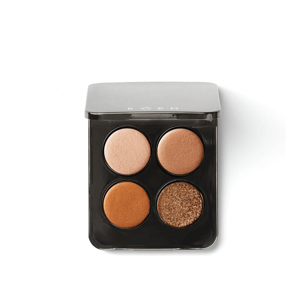 Four-shade eyeshadow palette with neutral tones, isolated on white background.