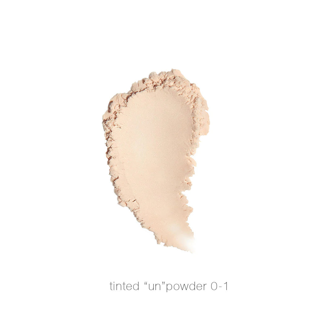 A swatch of tinted "un"powder shade 0-1 on a white background.