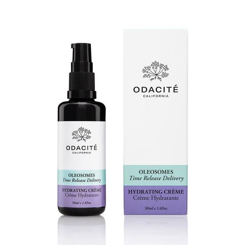 A bottle of odacite hydrating crÃ¨me next to its packaging box.