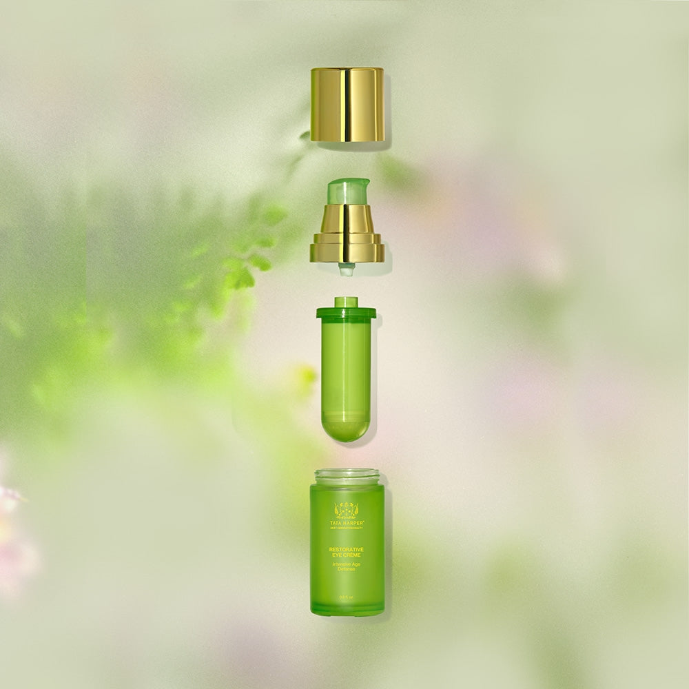 A serum bottle with a dropper, positioned in an exploded view, against a green botanical background.
