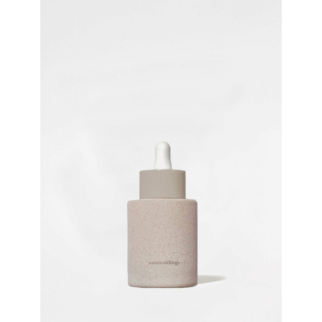 Bottle with a dropper in a minimalist design against a light background.