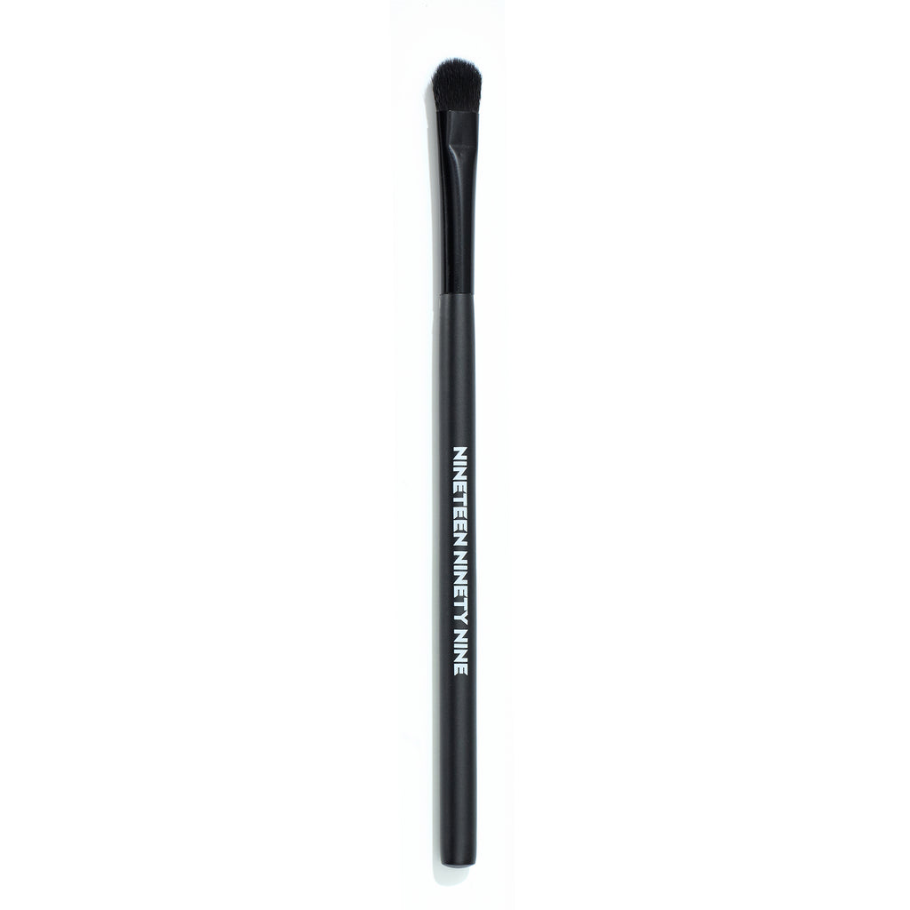 Black makeup brush with an angled bristle head on a white background.
