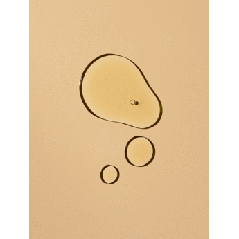 Oil droplets on a beige surface.