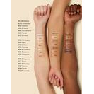A range of foundation shades swatched on three different arm skin tones to show color variation.