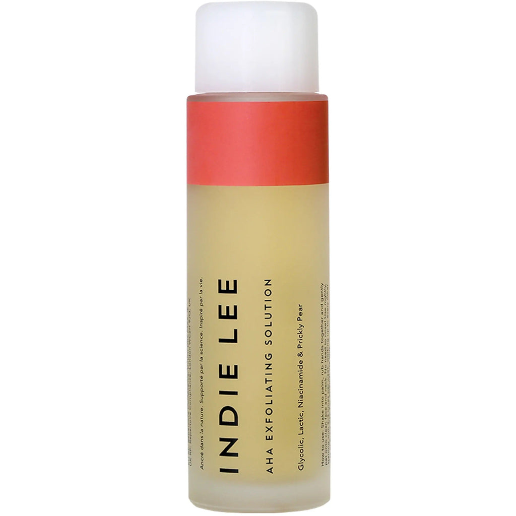 A bottle of indie lee exfoliating solution with a white and coral label.