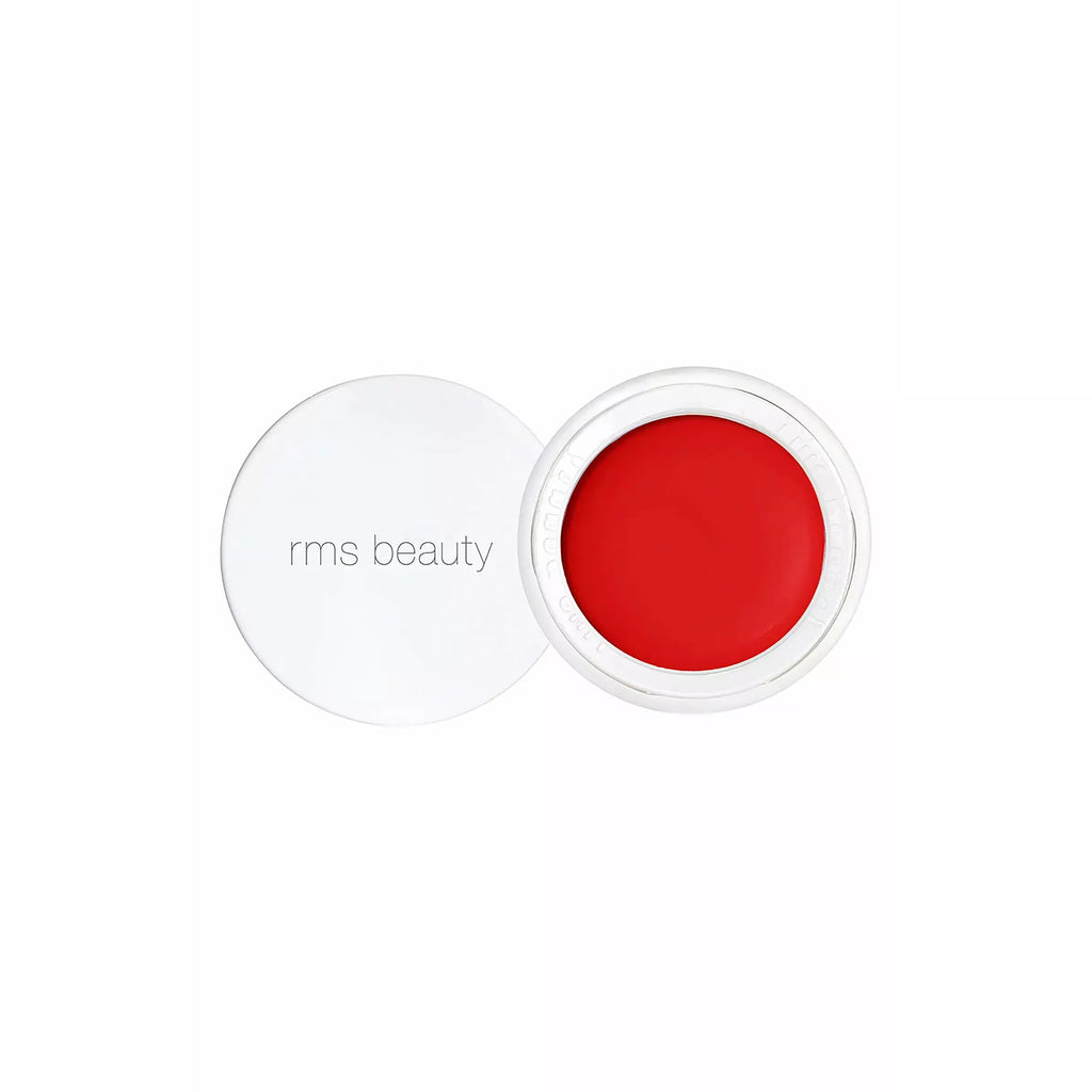 Opened container of red rms beauty product against a white background.