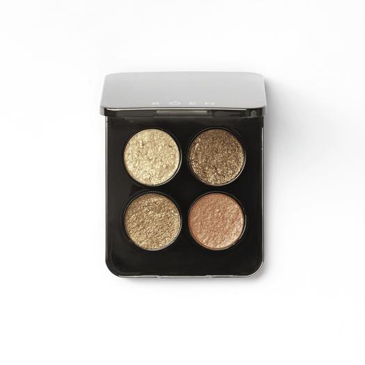 A compact with four shimmering eyeshadow shades against a white background.