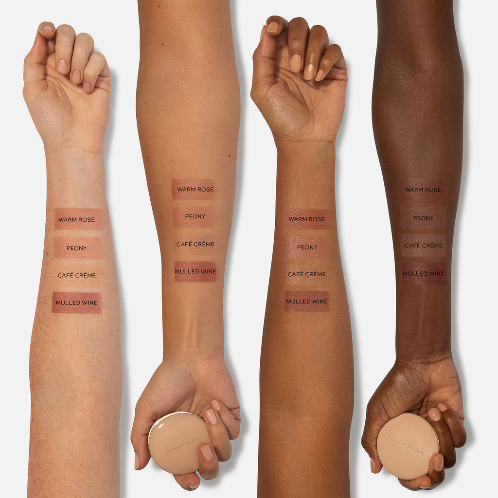 A variety of lipstick shades swatched on arms of different skin tones, showcasing color comparisons.