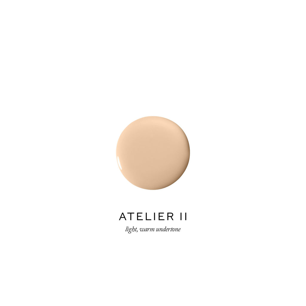 Dollop of light, warm-toned foundation against a clean, white background with the label "atelier ii.