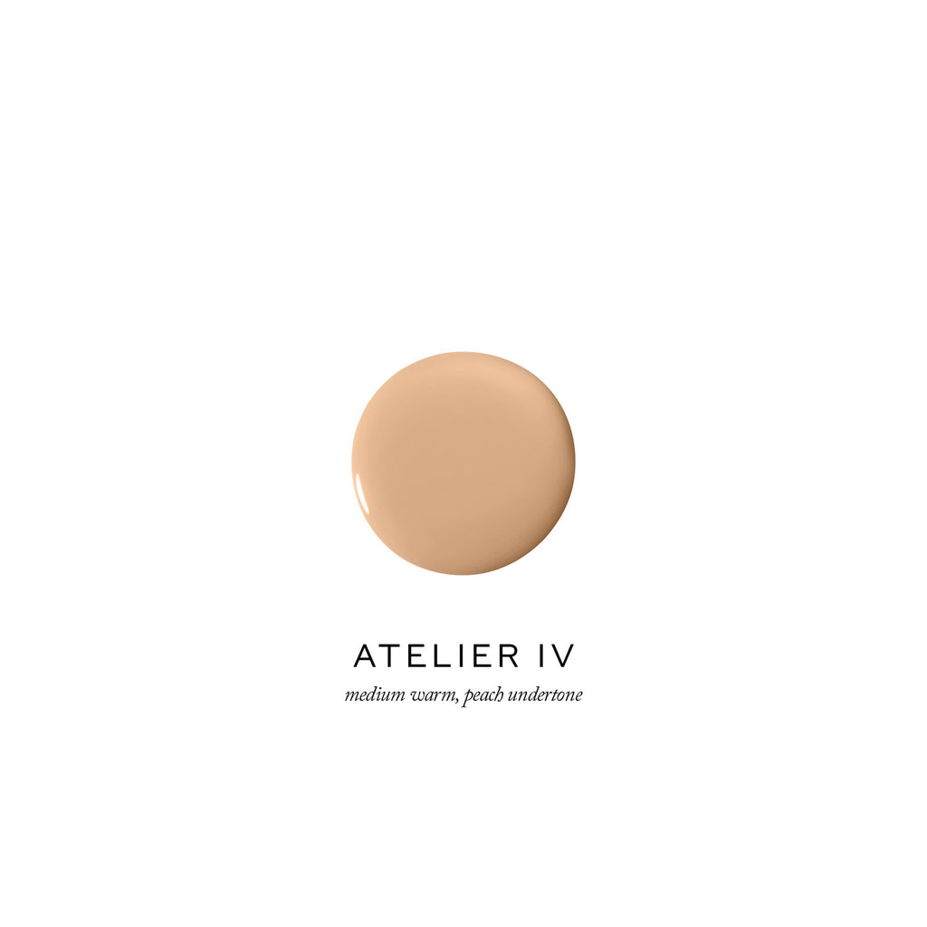 Swatch of foundation makeup with a medium warm, peach undertone labeled "atelier iv".