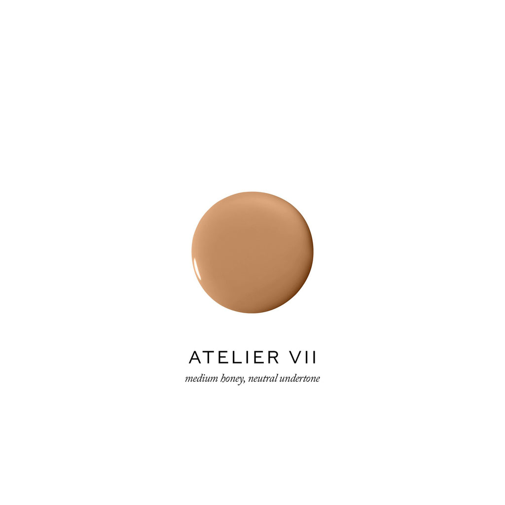 Dollop of medium beige foundation with a neutral undertone labeled "atelier vii".
