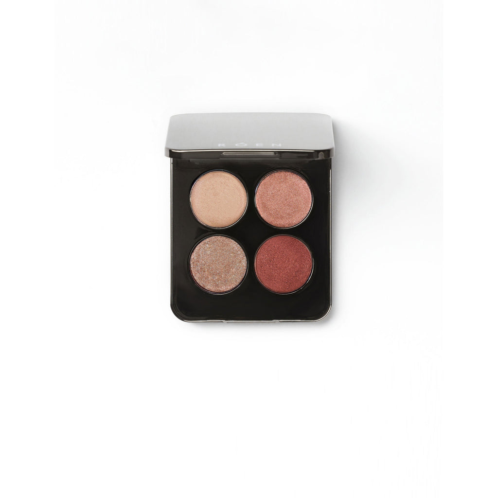 A quad eyeshadow palette with neutral shades on a white background.