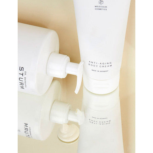 Three skincare products with pumps, positioned upside down to denote their near-empty status.