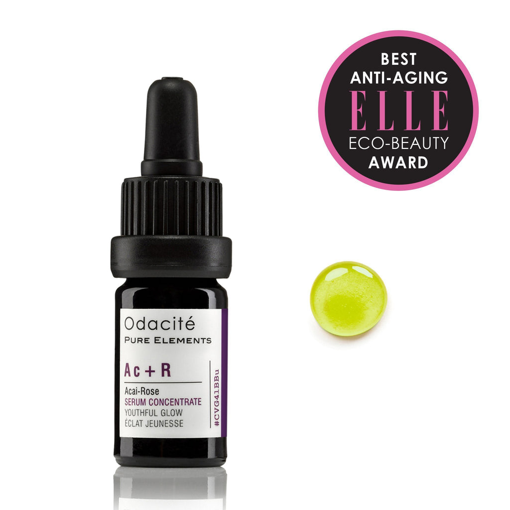 Bottle of odacite acai-rose youthful glow facial serum concentrate with a drop of the product and an award badge from elle magazine.