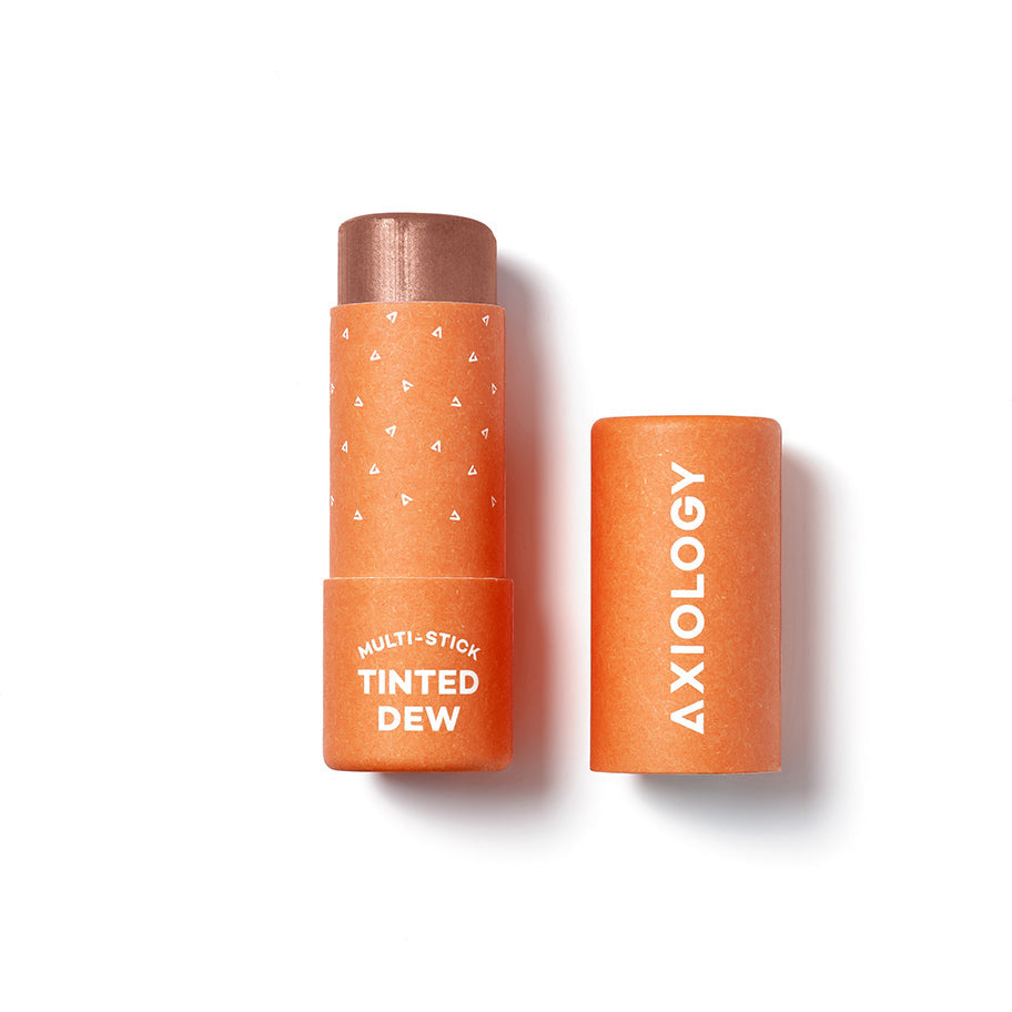 Multi-use tinted cosmetic stick with cap off, brand "axiology.