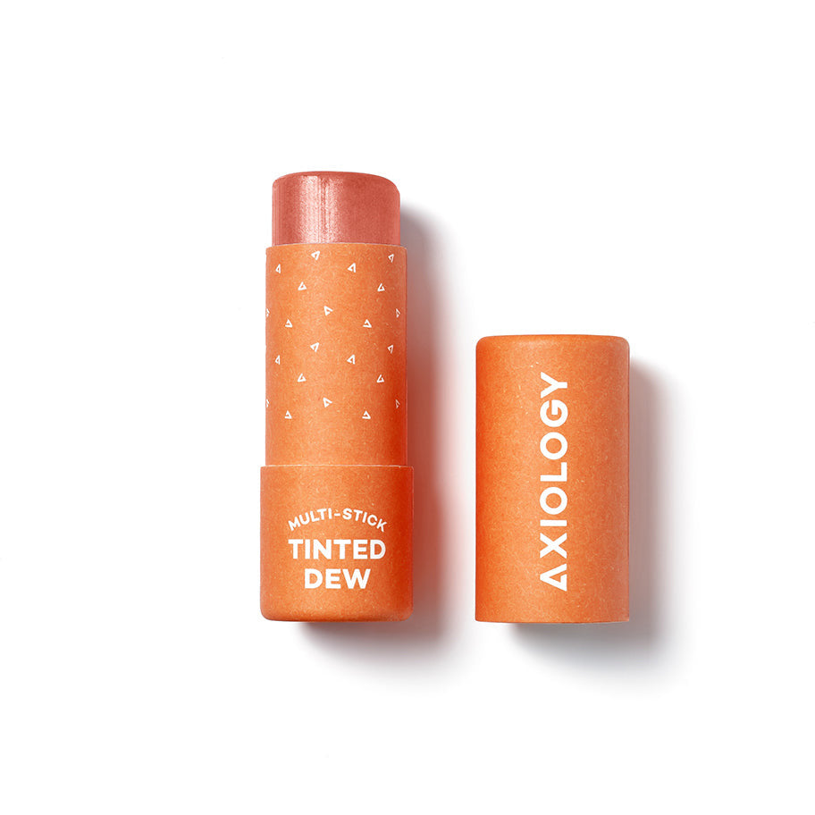 Axiology multi-stick in tinted dew shade with cap off, isolated on white background.