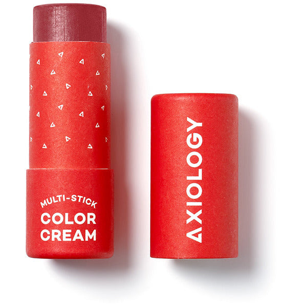 Two tubes of axiology multi-stick color cream cosmetics, one with the cap off to show the product.