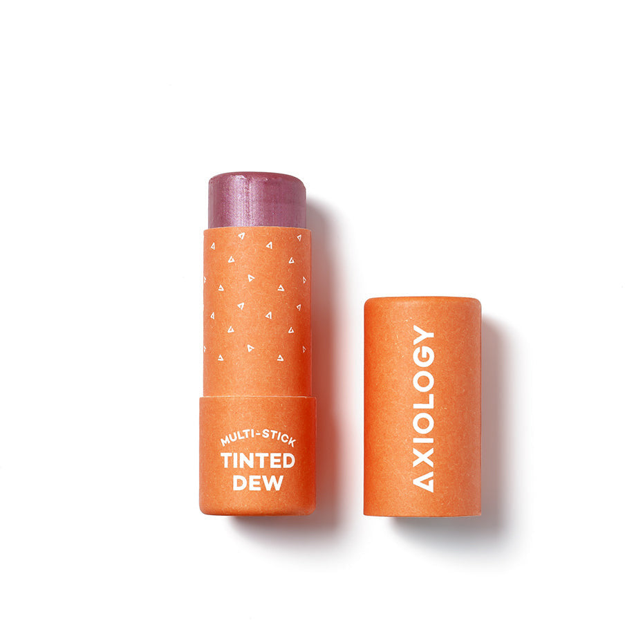 A tinted multi-stick makeup product by axiology with its cap removed, isolated on a white background.